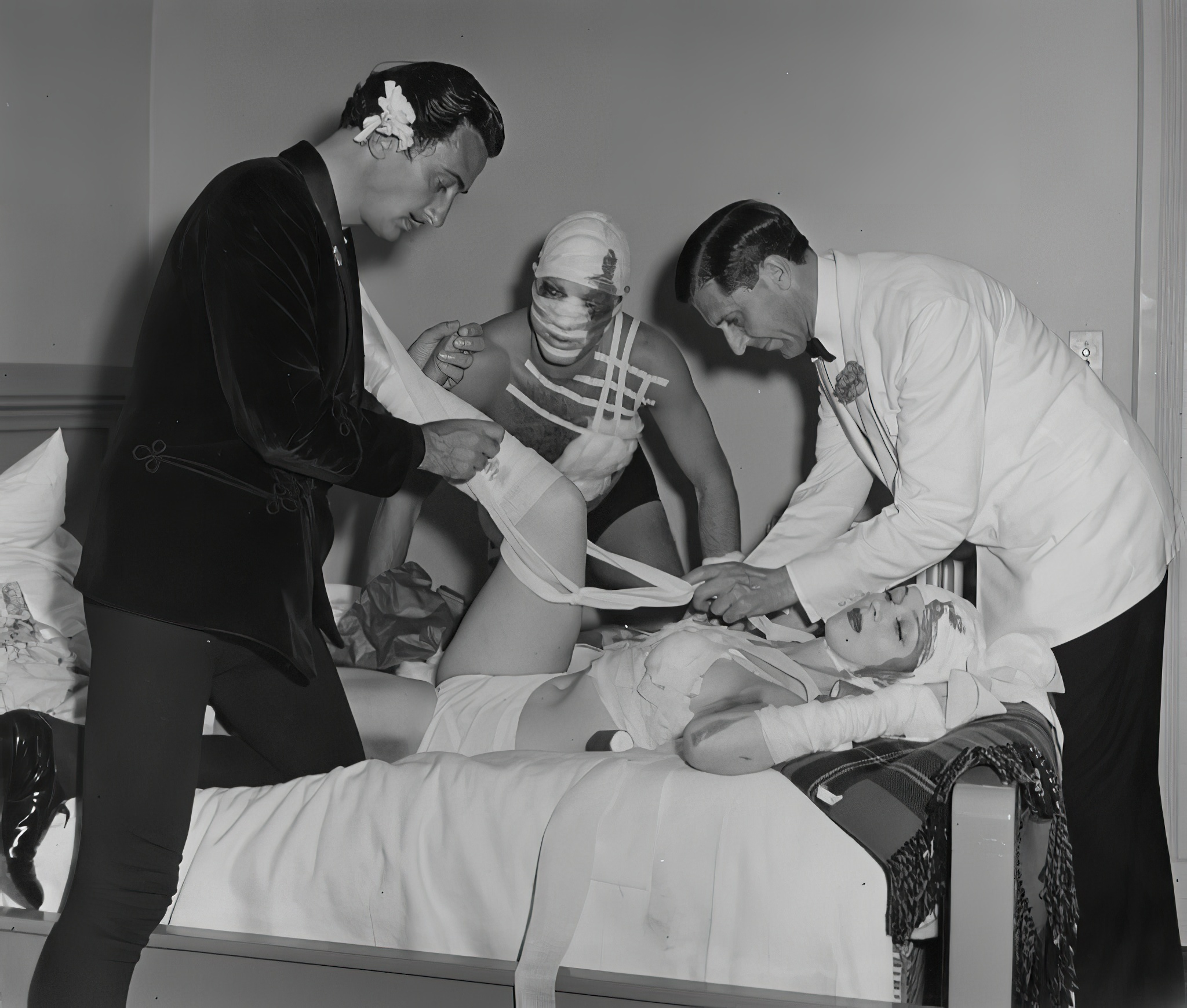 Salvador Dali and others bandaging up Lady Dancer. Hotel Del Monte, Monterey, California, 1941.