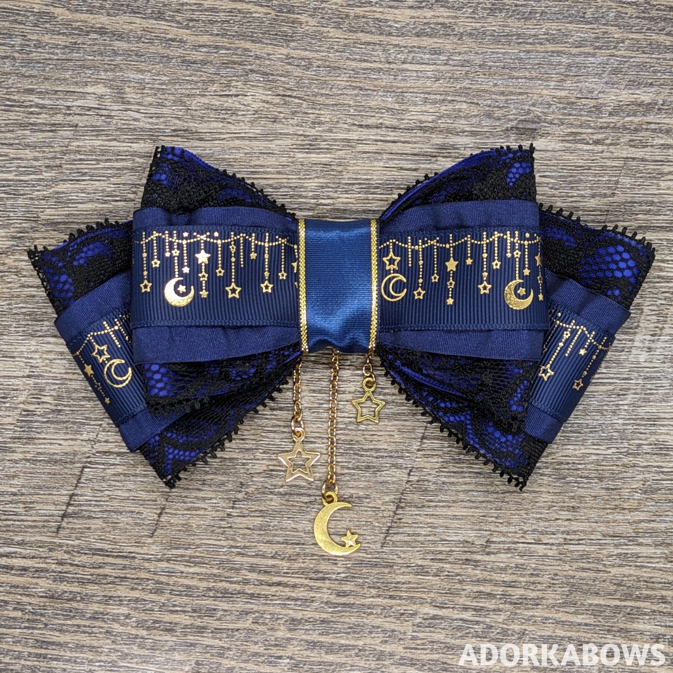 A handsewn navy hair bow with gold accents