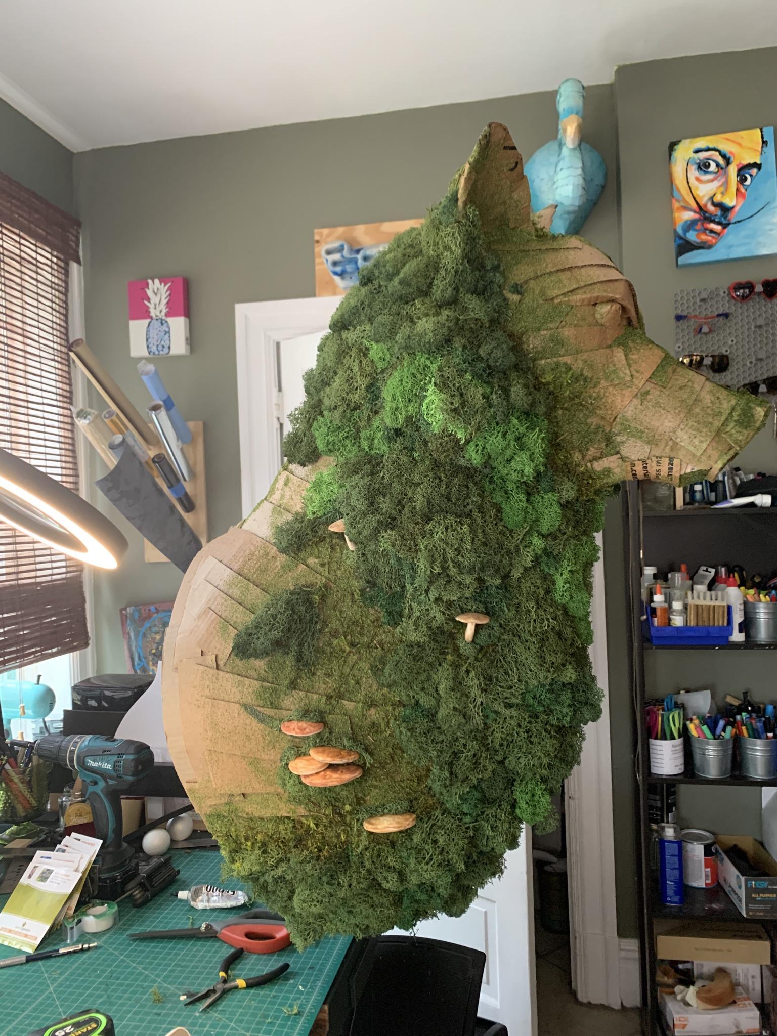 Cardboard wolf with moss and mushrooms