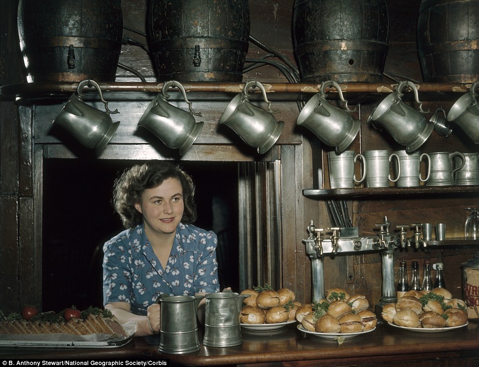 Carrier with a smile A lady stands uninteresting a bar loaded with sandwiches at a 17th-century inn in London. c1953