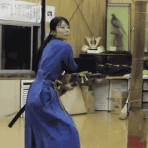 Eastern lady cuts twice a bamboo stick along with her katana old to it drops all the vogue down to the floor