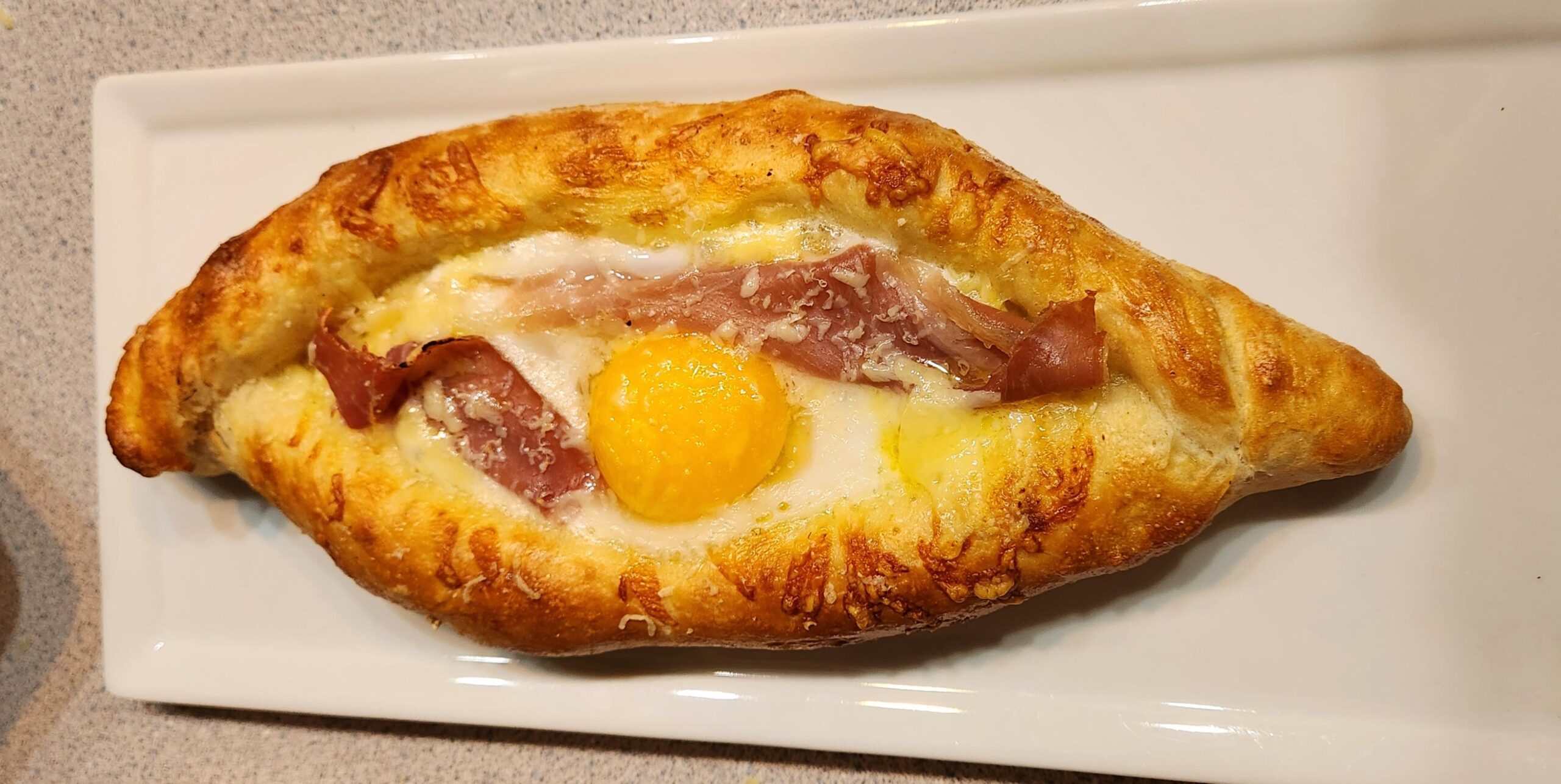 Khachapuri with brie, white cheddar, egg, prosciutto, and sausage gravy, with new grated parm, all from scratch. Sure, I know what it appears to be like to be like love. No, I’ve now not care.