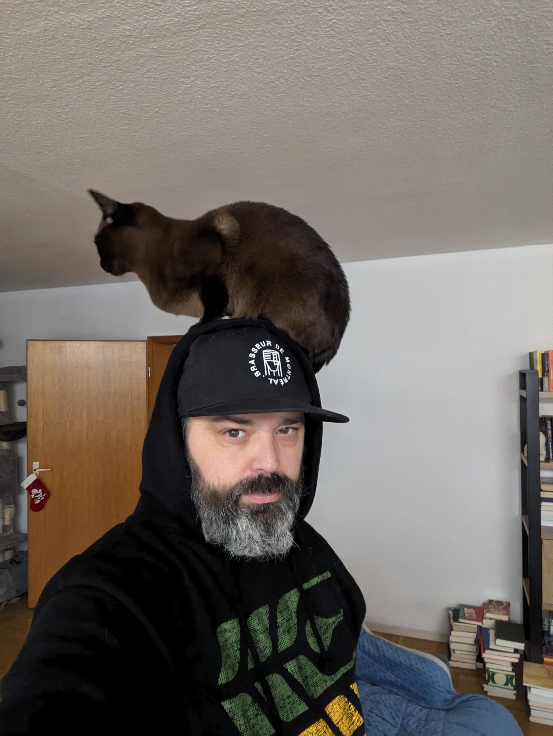 Dude from Saskatchewan, hat from Montreal, cat is Burmese, positioned in Germany.