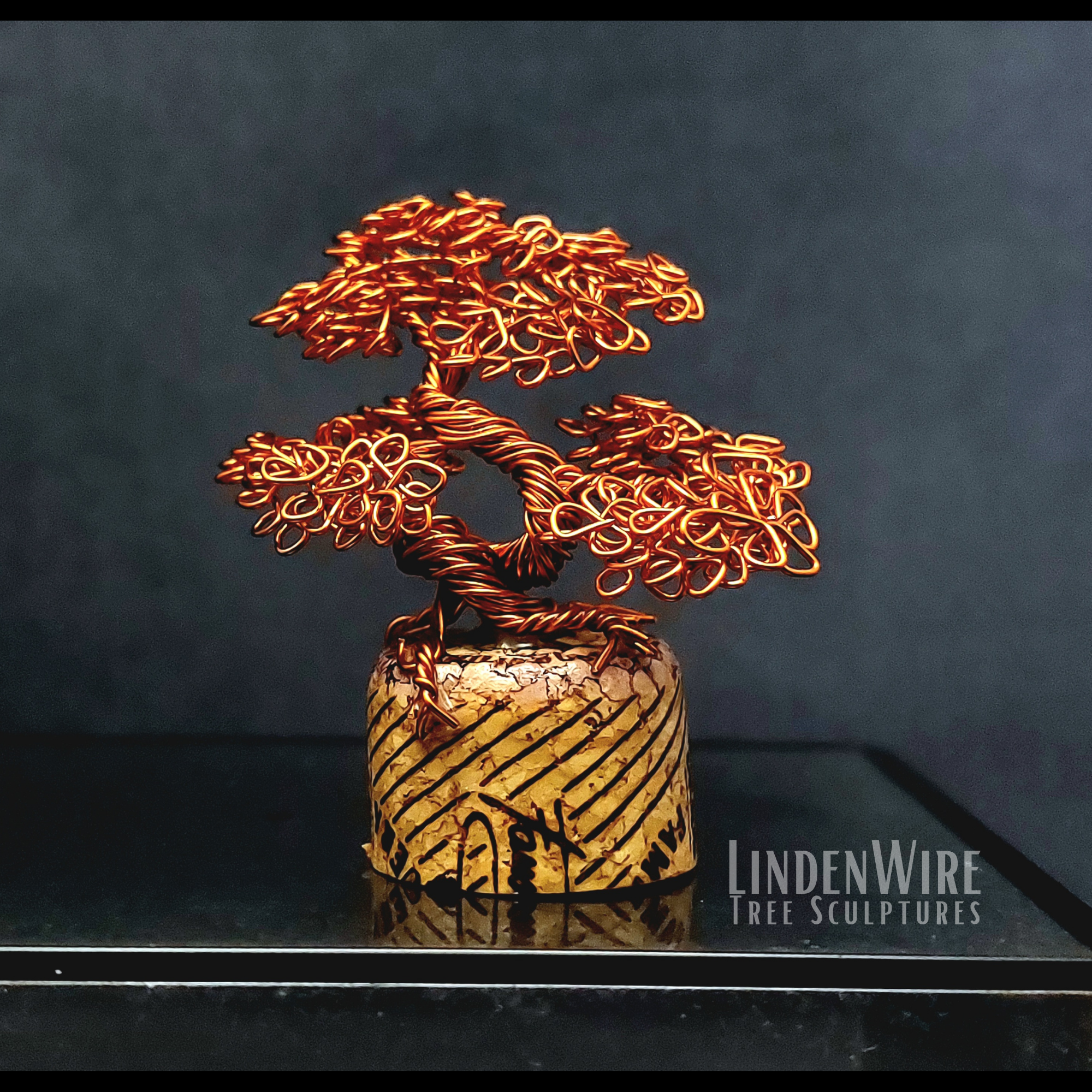 Miniature bonsai tree sculpture on a wine cork